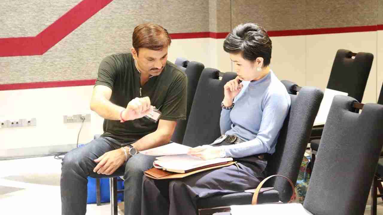 Hypnotherapy instructor working with a trainee during a certification program.