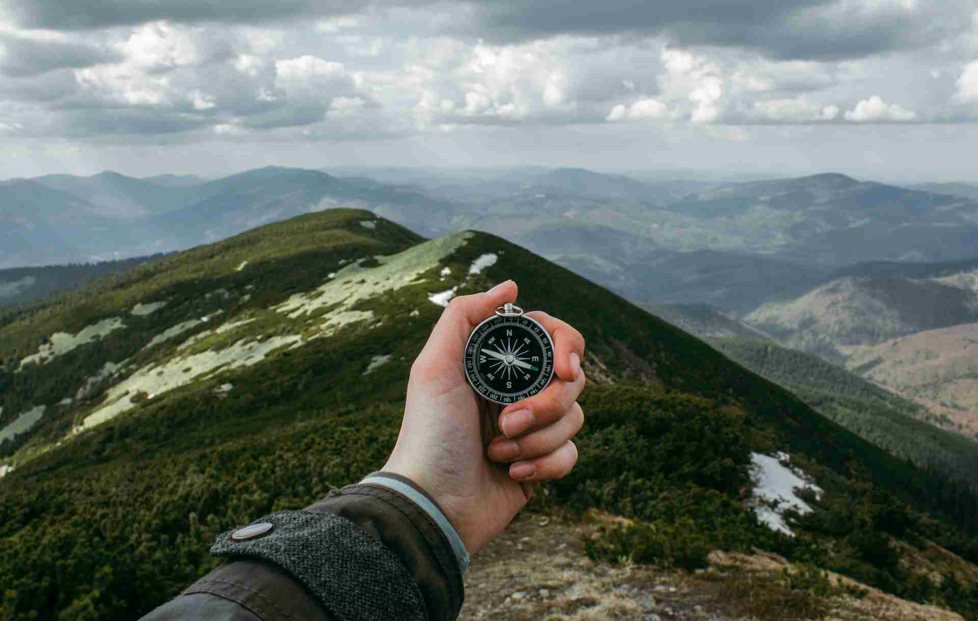 Man holding a compass representing the realness of neuro-linguistic programming